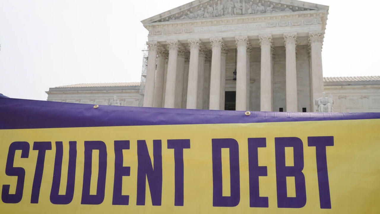 A sign with the words "student debt" outside the Supreme Court building