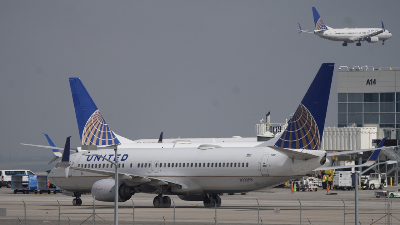 A United Airlines jetliner taxis down a runway at Denver International Airport.