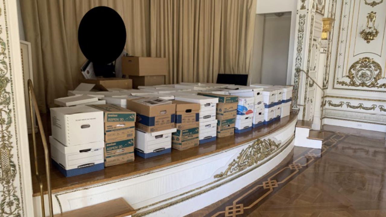 Boxes of records being stored on the stage in the White and Gold Ballroom at Trump's Mar-a-Lago estate.