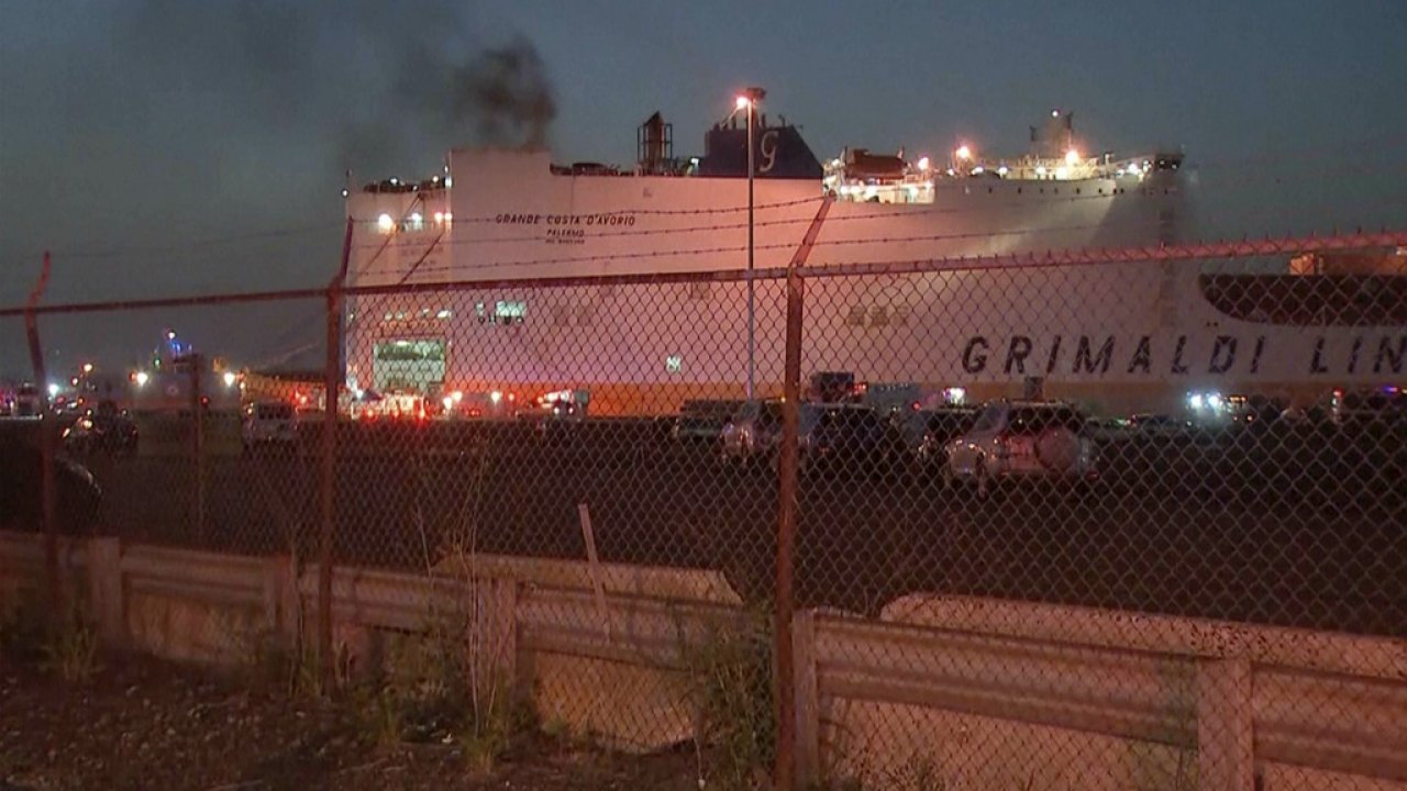 Smoke billows from cargo ship.