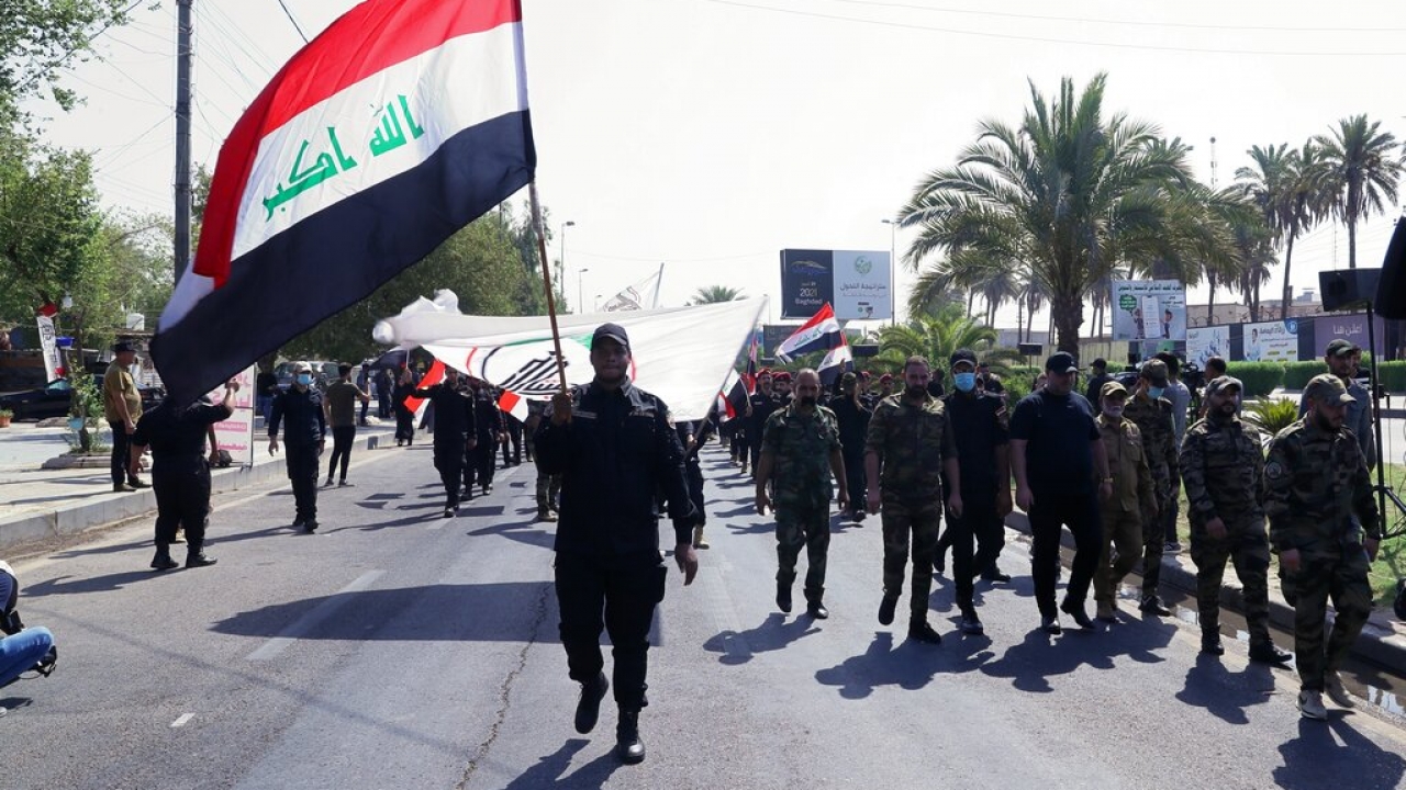 Iran-backed militia fighters march in central Baghdad, Iraq.