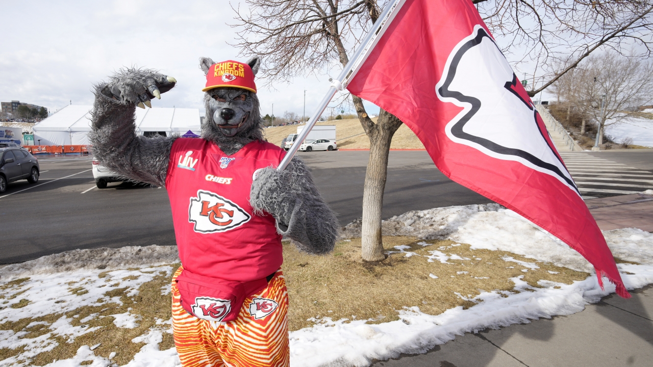 A Kansas City Chiefs fan, Chiefsaholic, poses for photos while walking toward Empower Field at Mile High.
