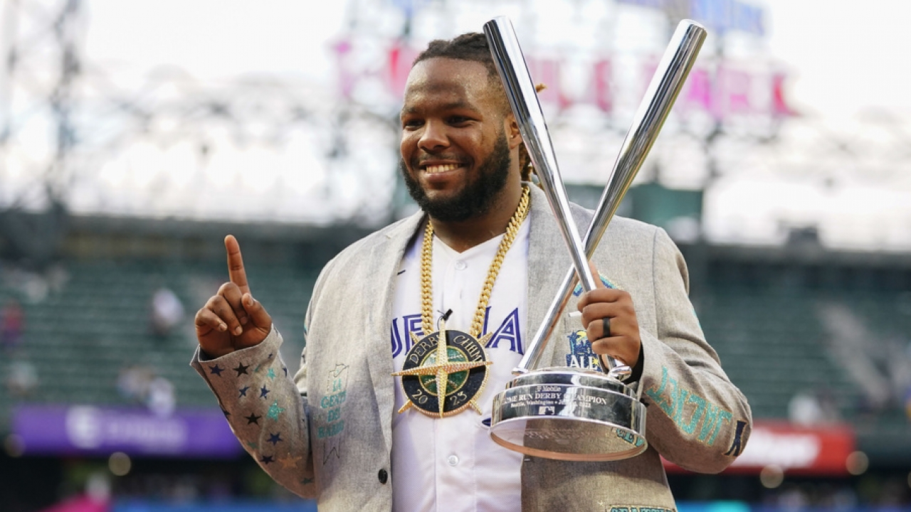 Vladimir Guerrero Jr. poses with the MLB All-Star Home Run Derby trophy.