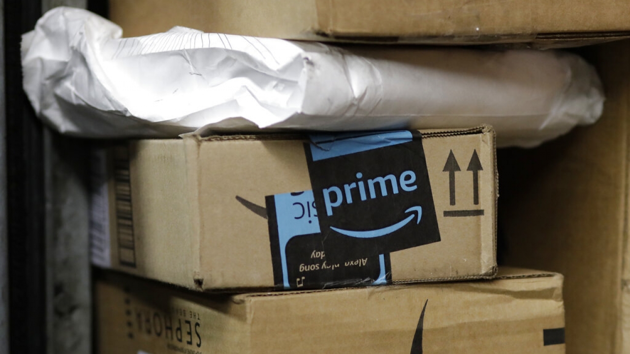 A package from Amazon Prime is loaded for delivery on a truck
