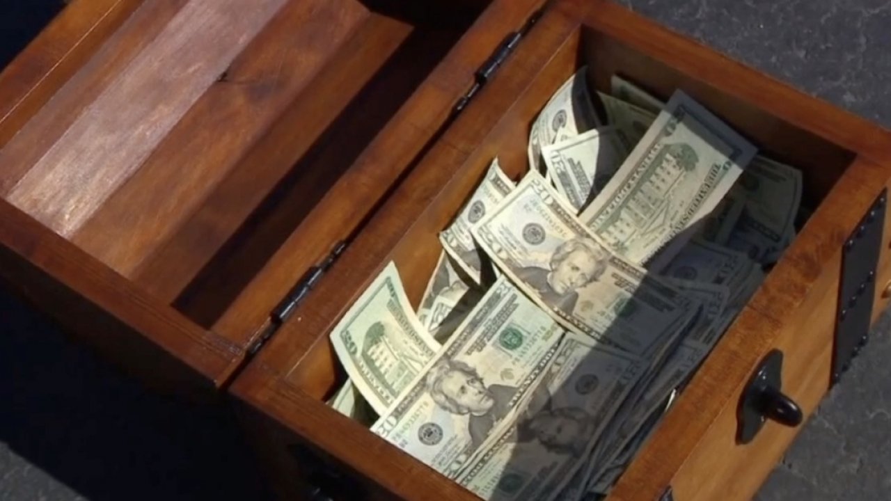 A treasure chest with cash inside.