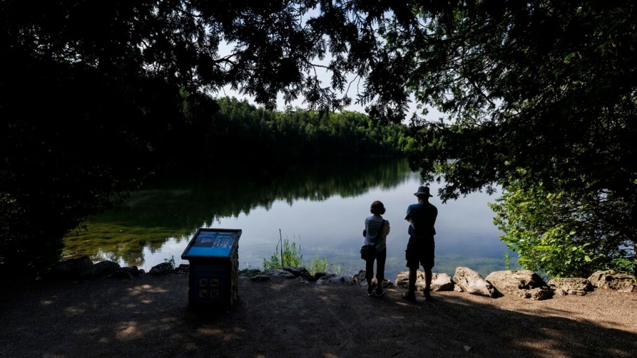 People look at Crawford Lake in Canada