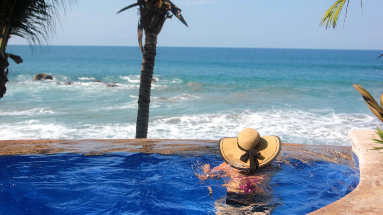 A hotel guest in Mexico takes in the view of the Pacific Ocean.