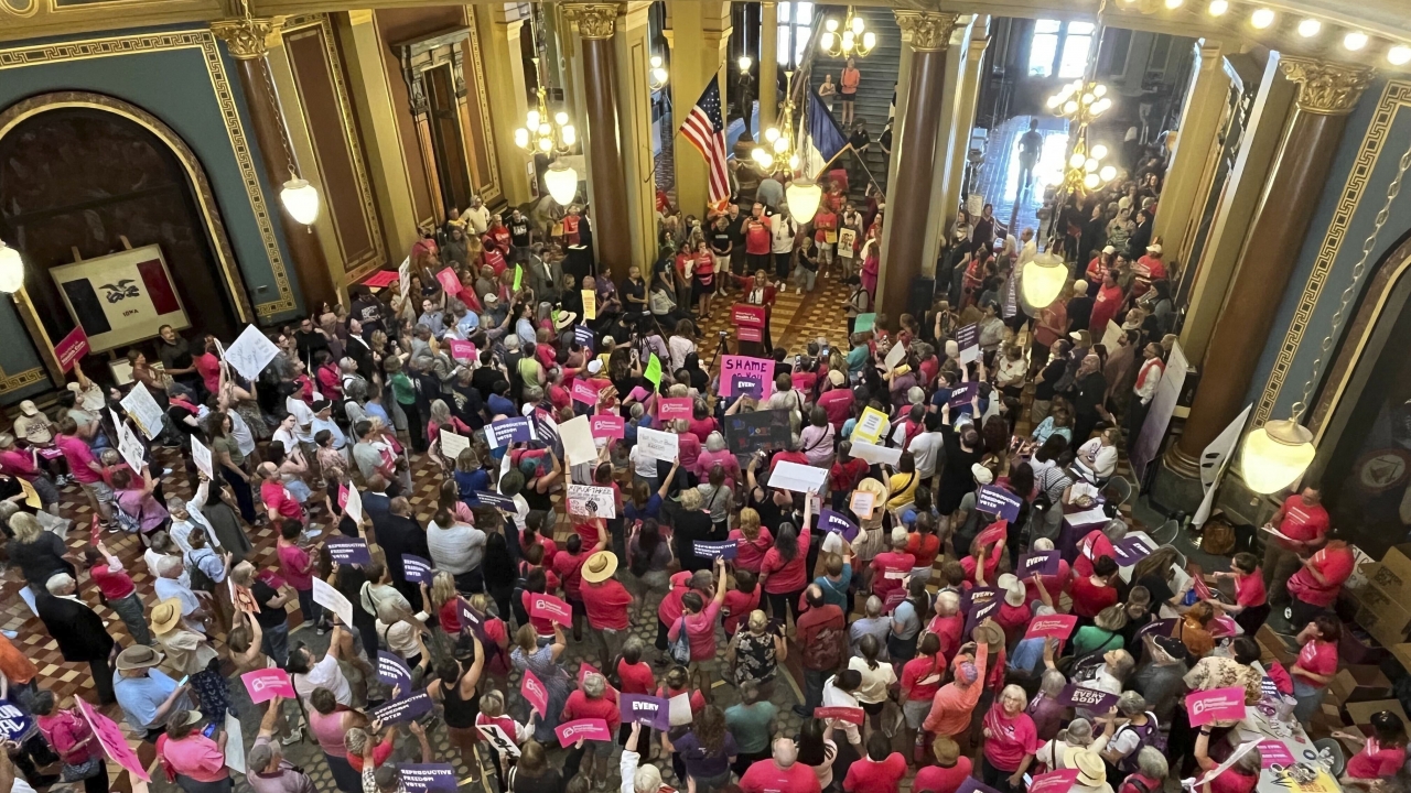 Iowa Democrat Jennifer Konfrst speaks to protesters rallying at the Iowa Capitol rotunda.