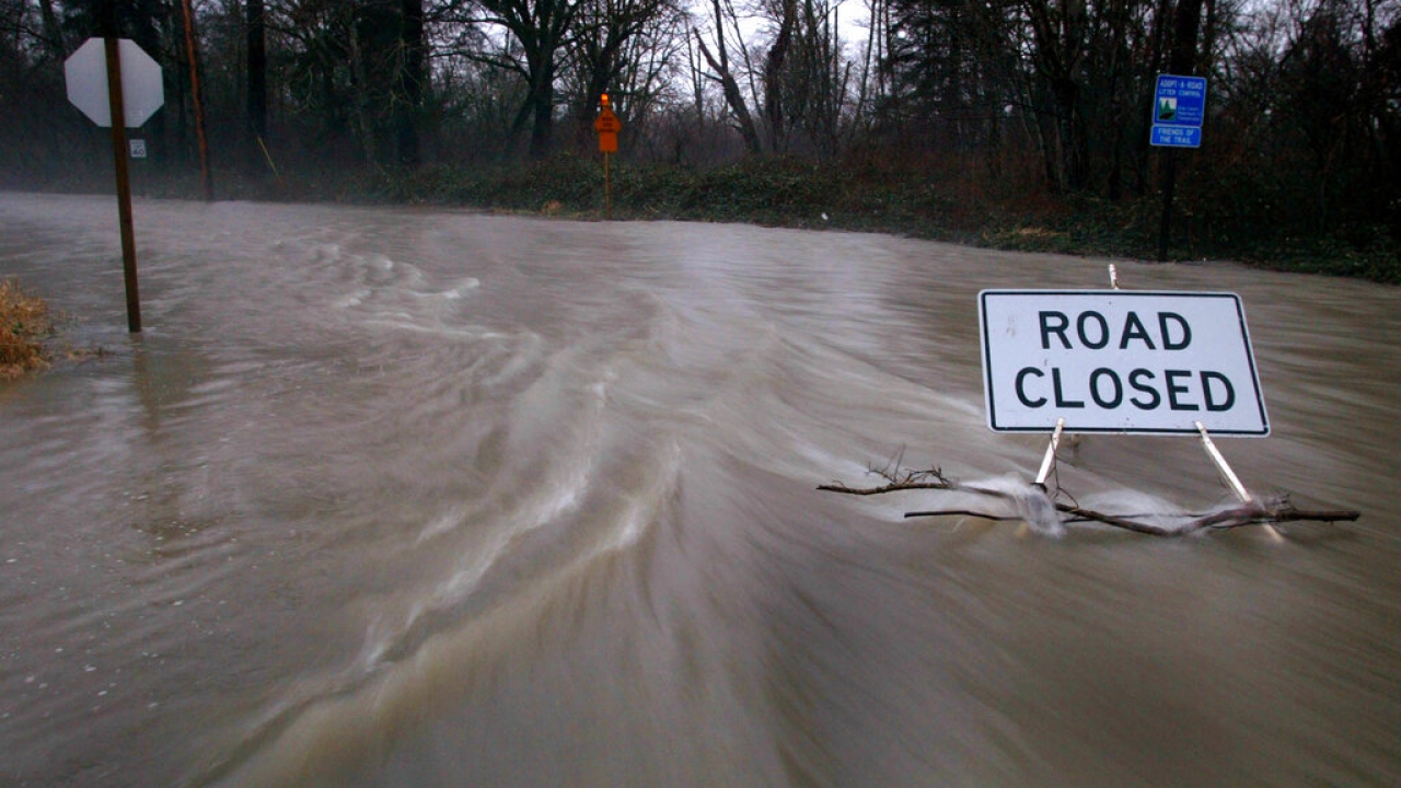Flooded road with a "Road closed" sign