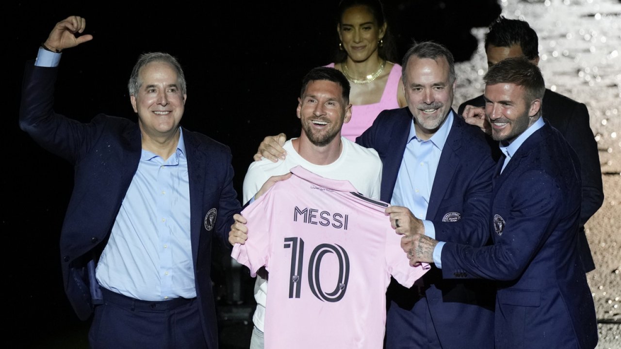 Lionel Messi holds his new Inter Miami team jersey.