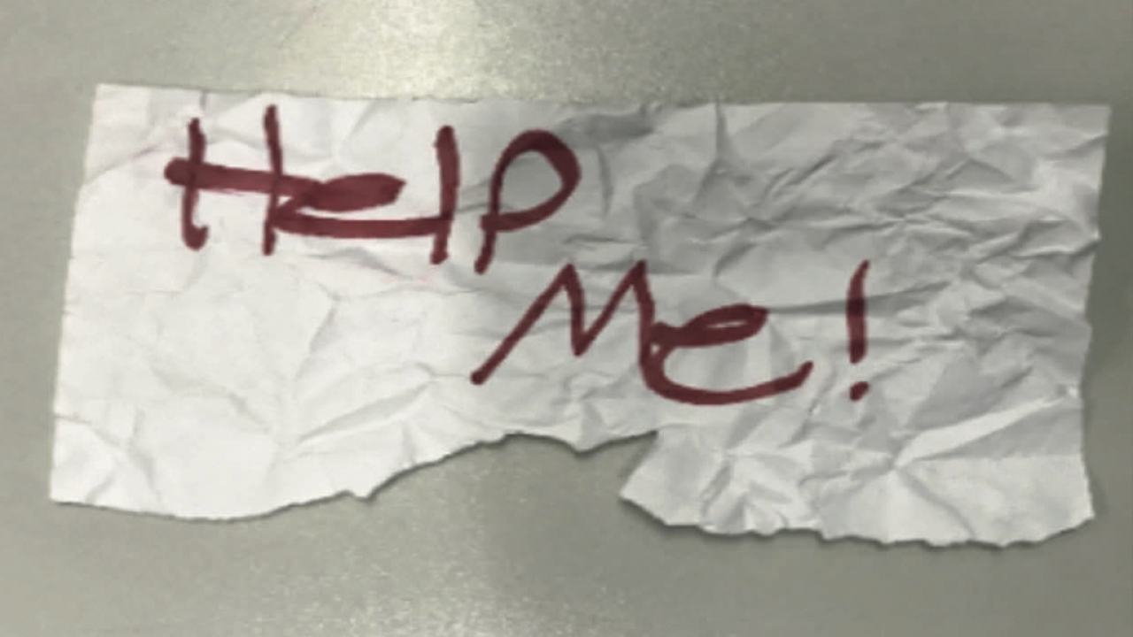 A "Help Me!" sign used by a 13-year-old girl kidnapped in Texas is shown.