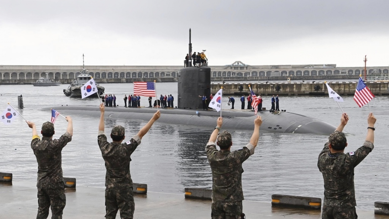 South Korean navy sailors wave as the USS nuclear-powered submarine USS Annapolis arrives at a South Korean naval base.
