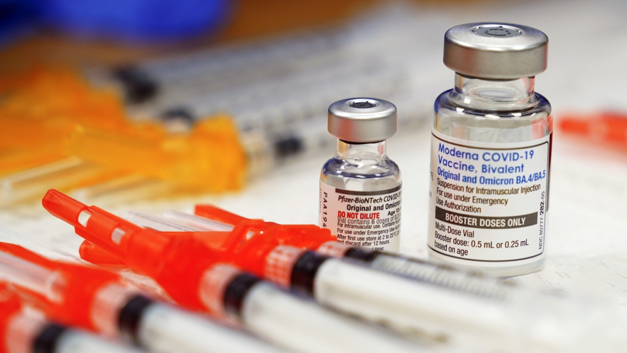 Pfizer, left, and Moderna bivalent COVID-19 vaccines are readied for use at a clinic.