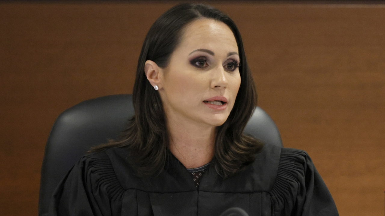 Judge Elizabeth Scherer is shown.