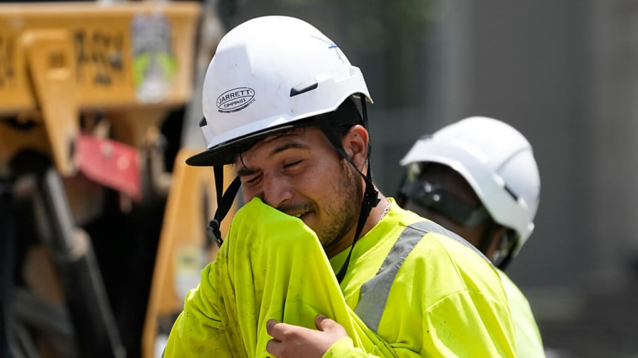A construction worker wipes his face while working outdoors in Tennessee.