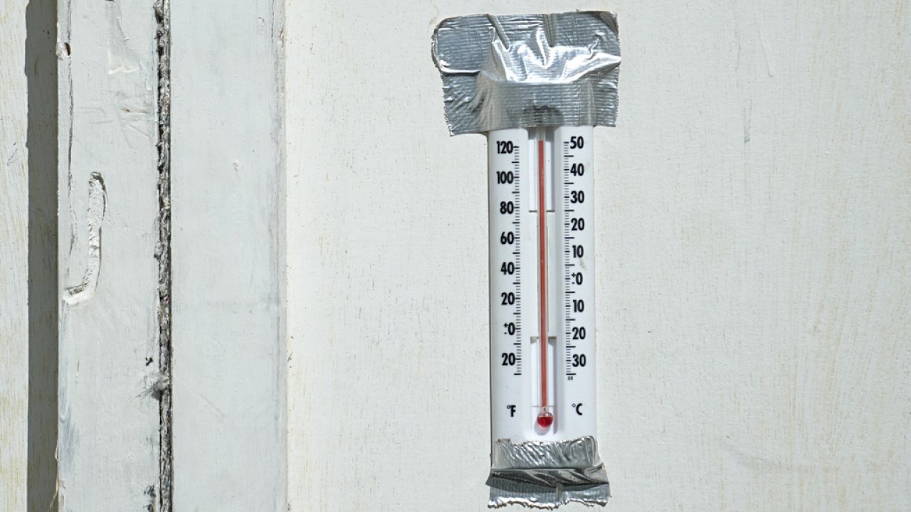 A thermometer shows temperatures over 120 degrees Fahrenheit.