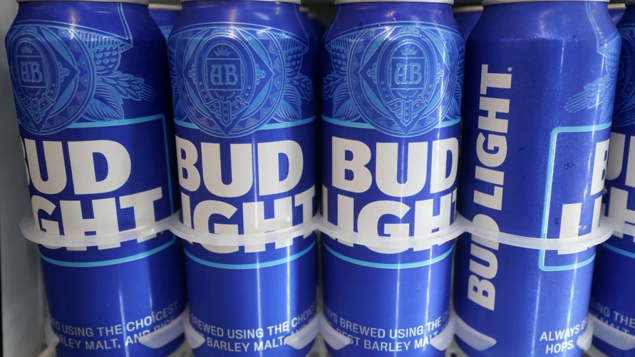 Cans of Bud Light chill in a refrigerator.