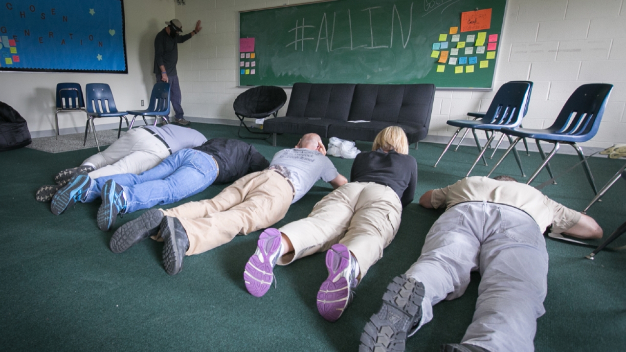 Teachers play dead during a lockdown drill.