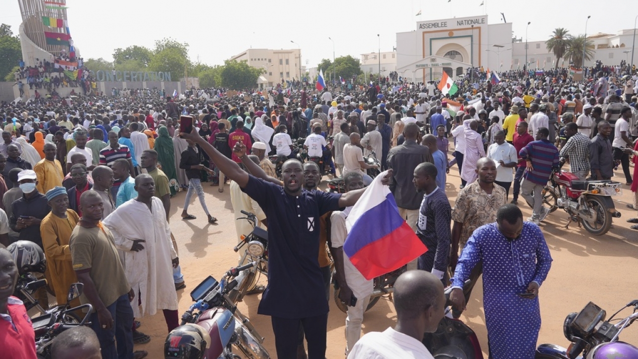 Nigeriens, some holding Russian flags, participate in a march.