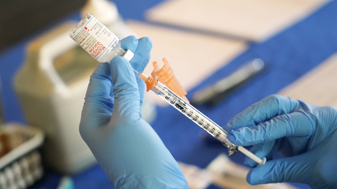A nurse prepares a syringe of a COVID-19 vaccine at an inoculation station in Jackson, Miss., July 19, 2022.