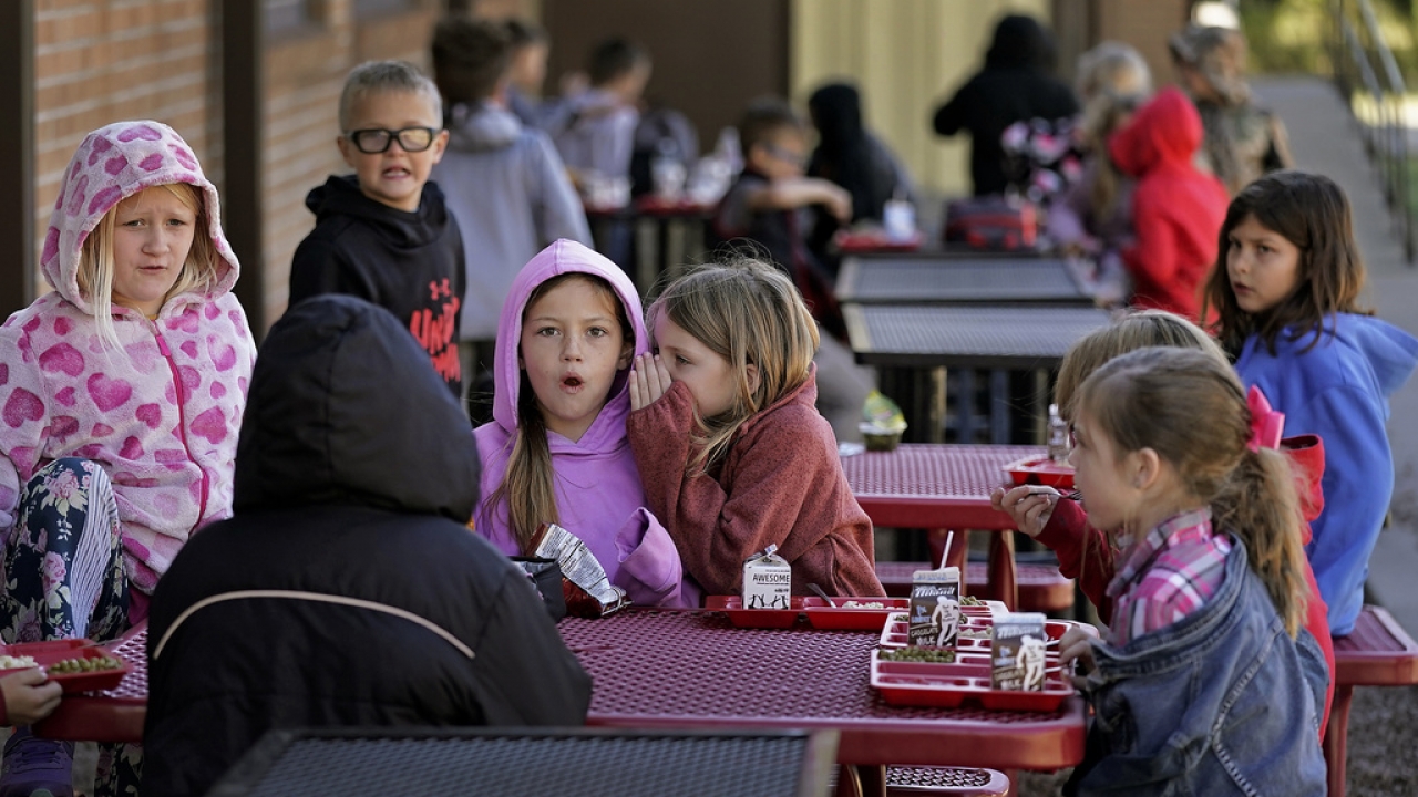 Third graders have lunch outdoors at Highland Elementary School in Columbus, Kan.