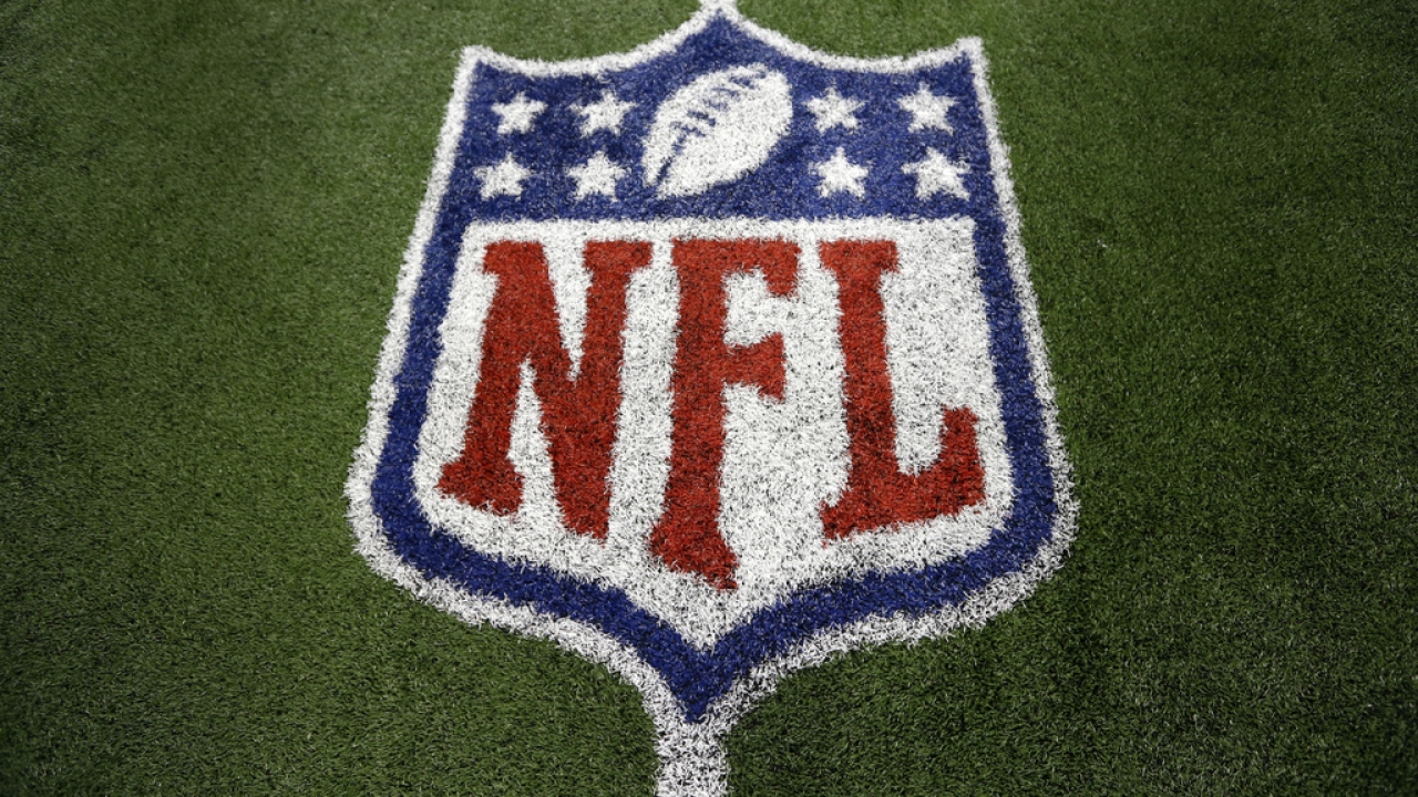 An NFL logo on the field after a football game