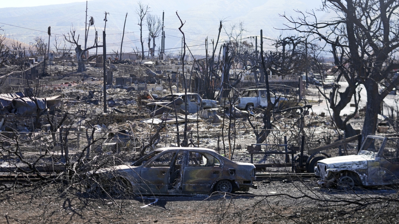 Destroyed homes and cars are shown, Sunday, Aug. 13, 2023, in Lahaina.