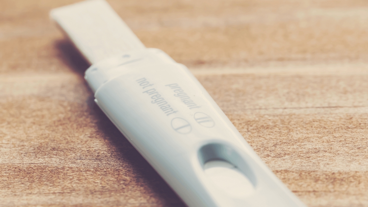 A pregnancy test lies on a table