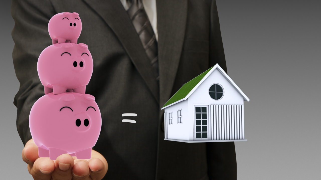 Photo illustration of piggy banks and a house