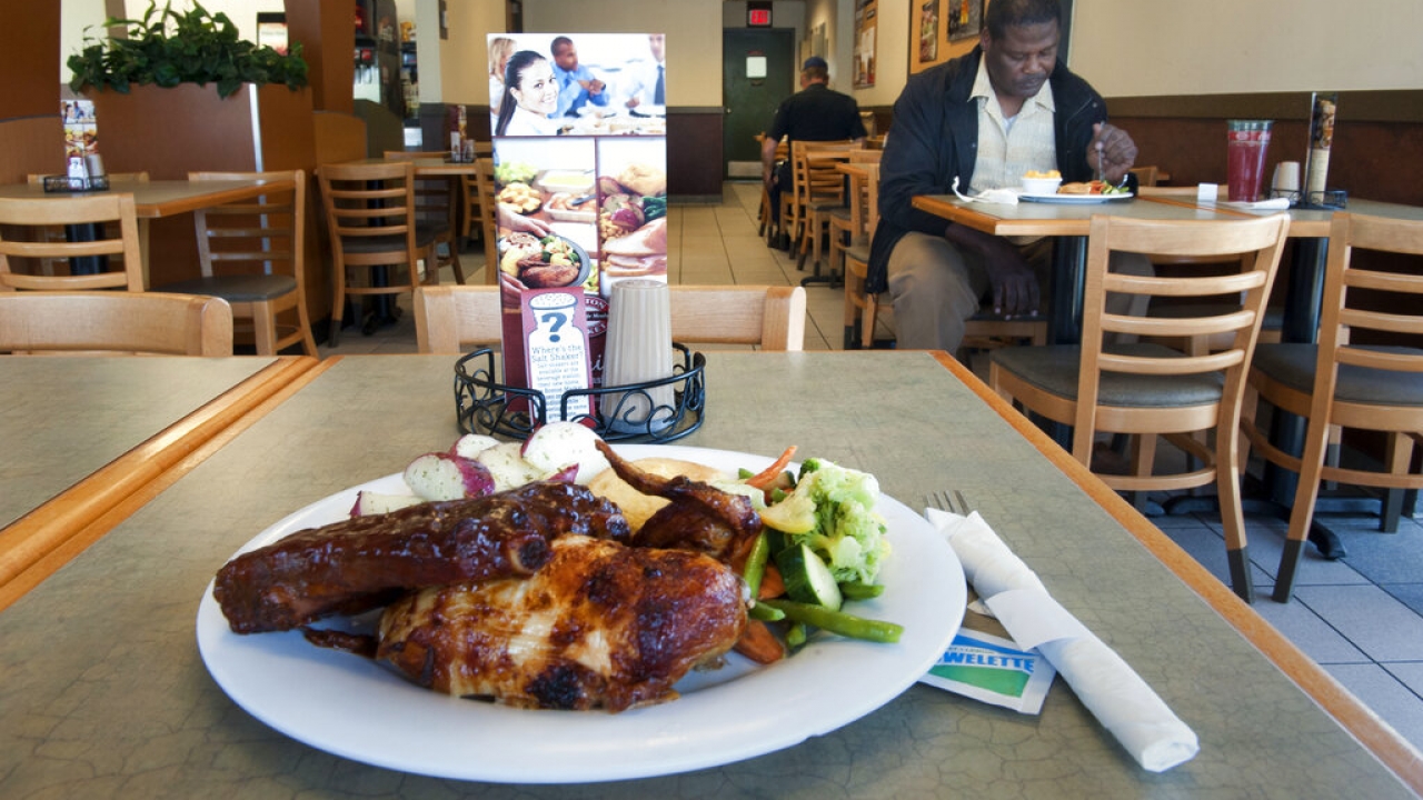 A chicken and veggie meal sits on table at Boston Market restaurant.