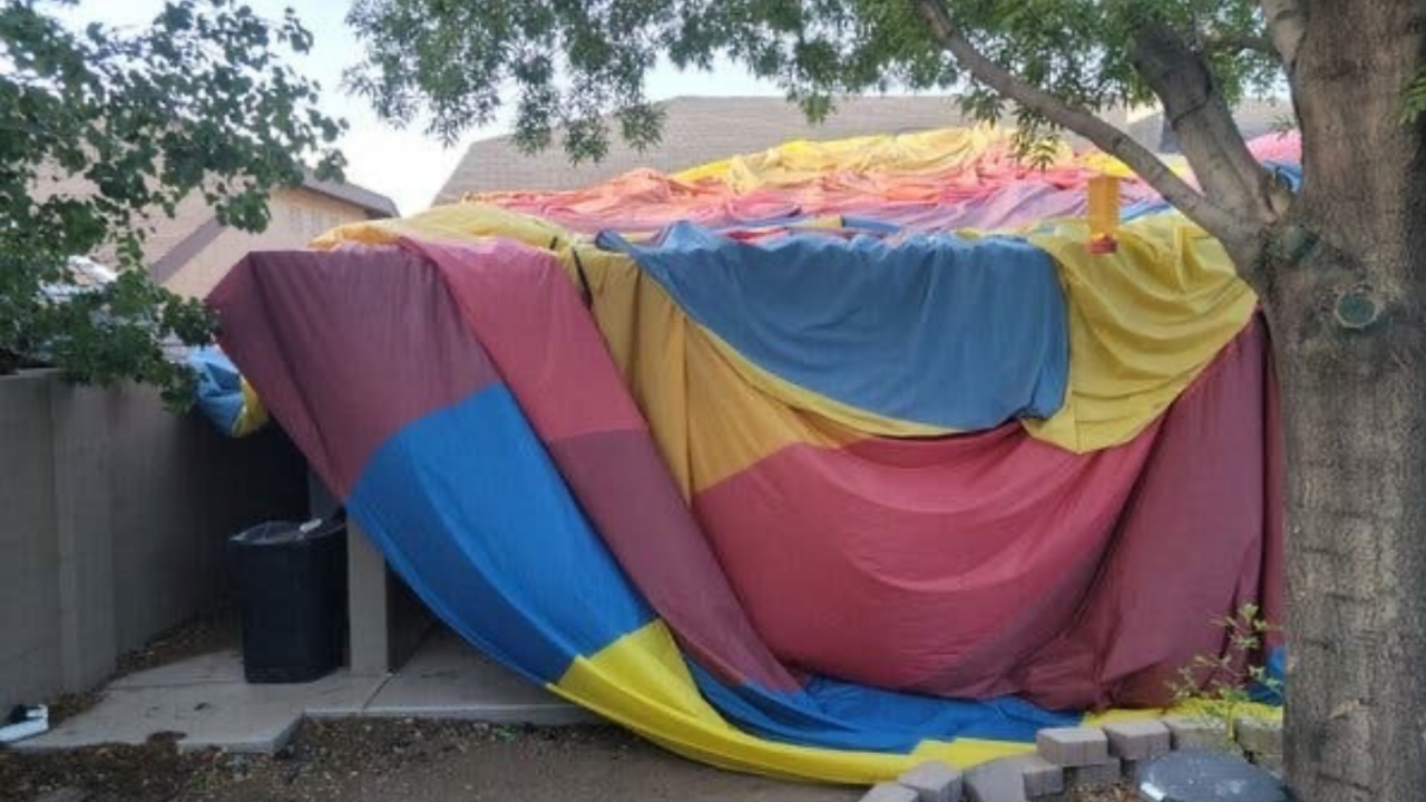 Hot air balloon envelope laying on the private residence’s rooftop.