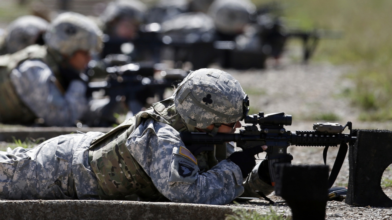 Female soldiers train on a firing range.