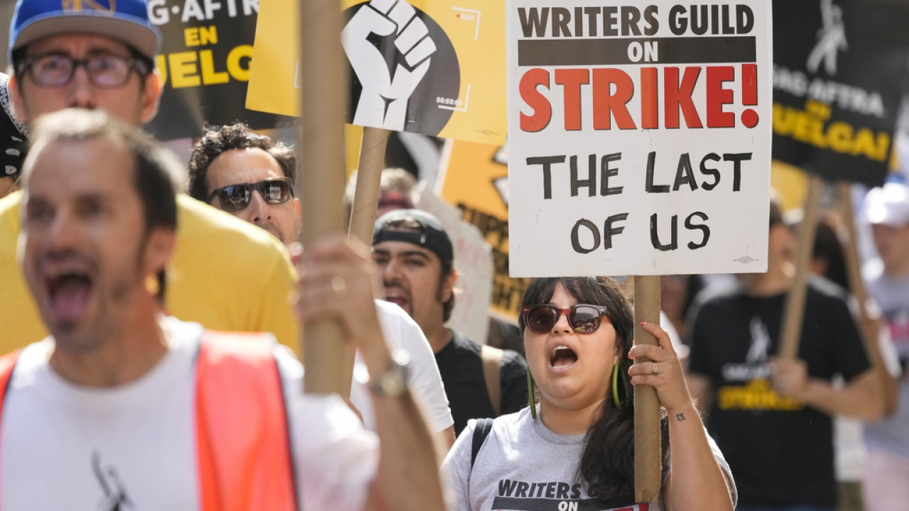 Strikers walk a picket line outside Warner Bros., Discovery, and Netflix offices in Manhattan.