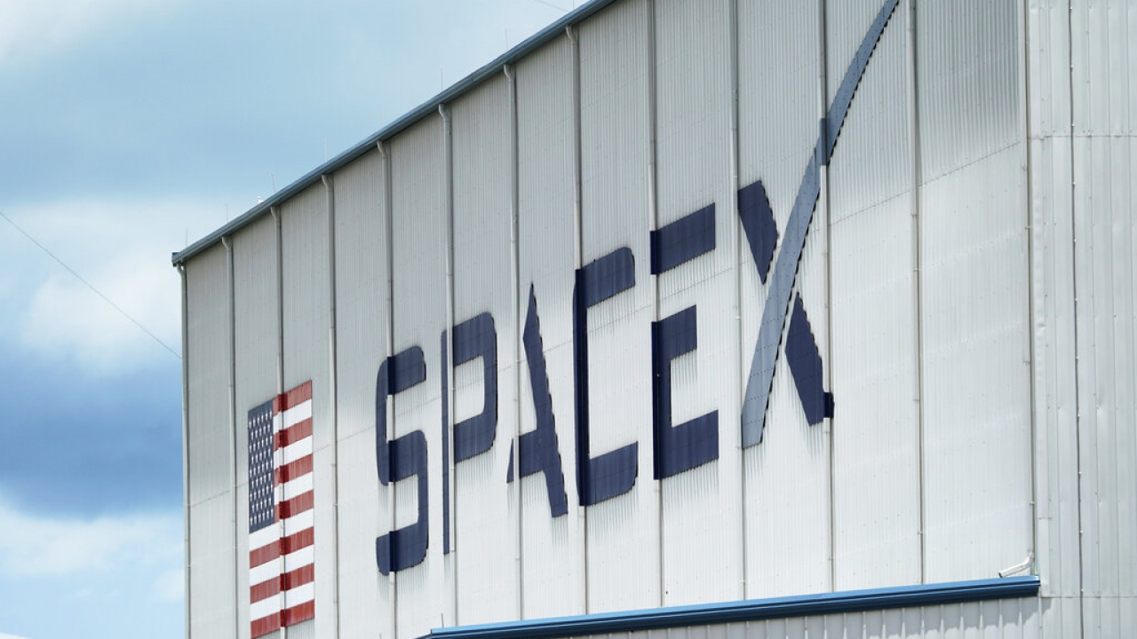 The SpaceX logo is displayed on a building.