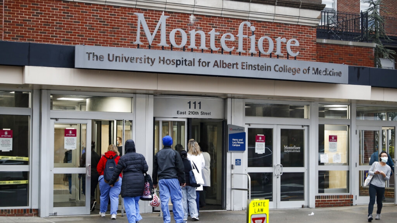 Medical workers enter Montefiore Medical Center.