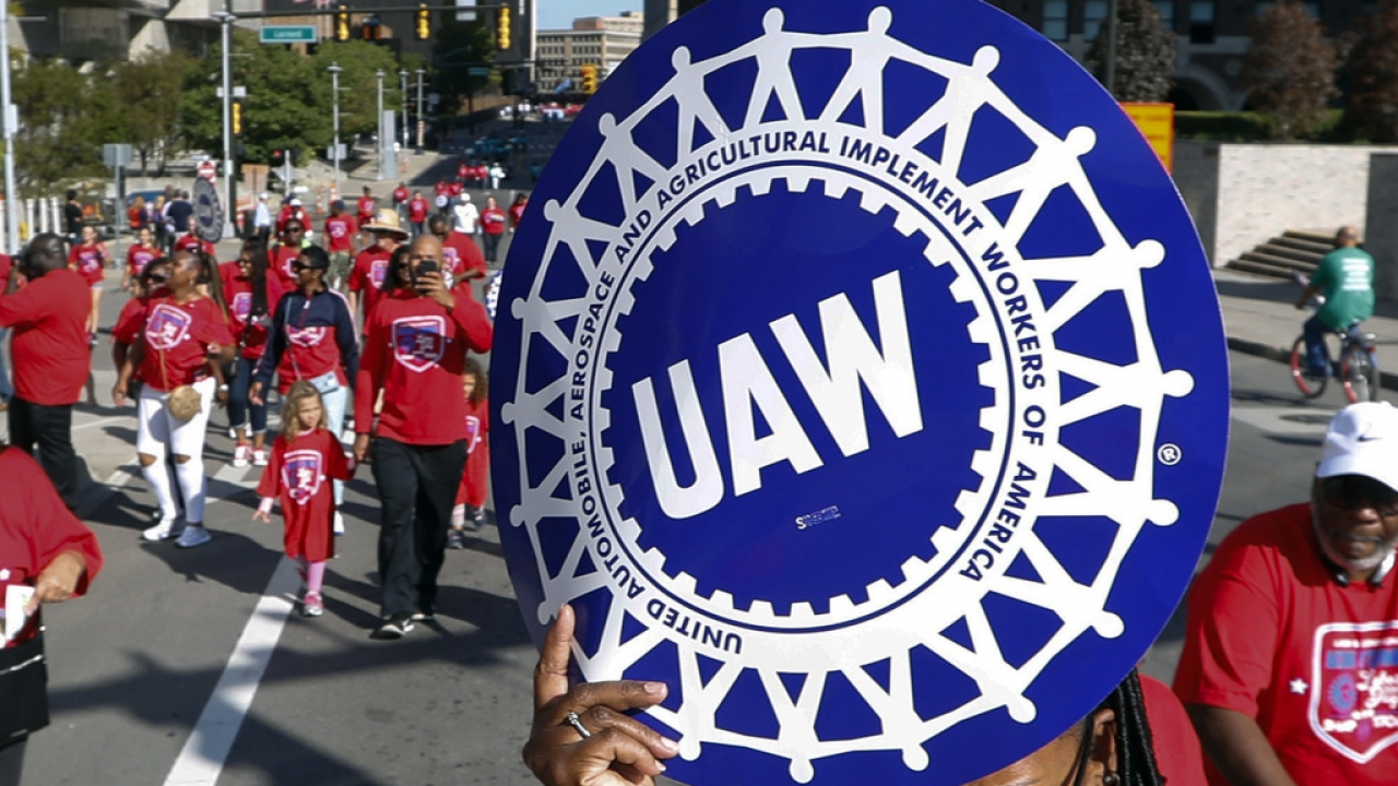 United Auto Workers members walk in the Labor Day parade in Detroit.