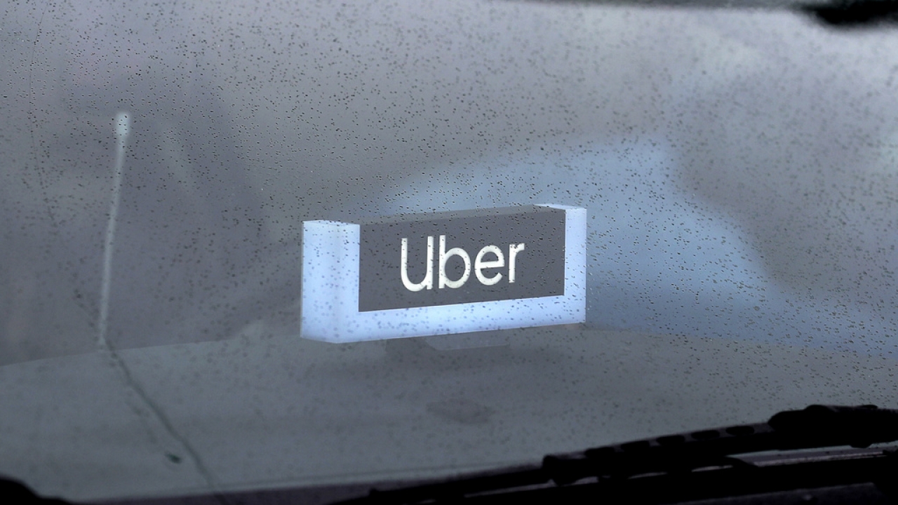 An Uber sign is displayed inside a car in Chicago.