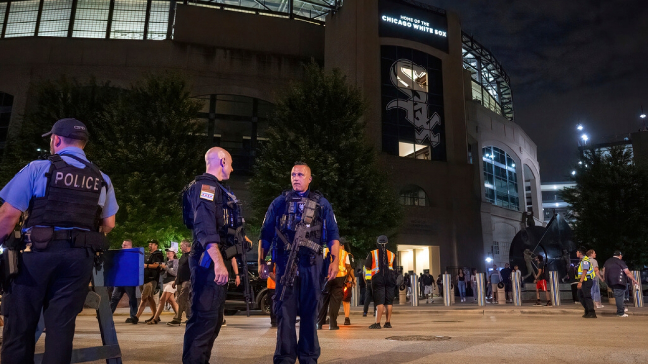 Chicago police officers stand outside Guaranteed Rate Field.