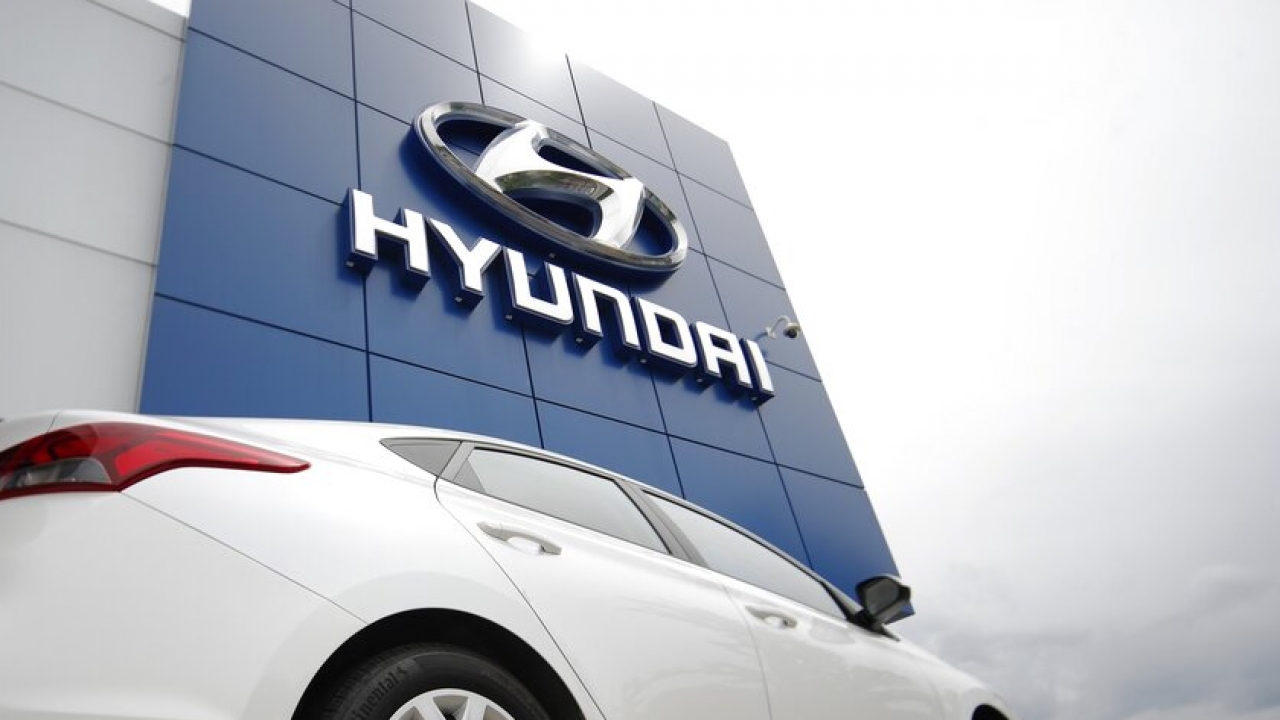 A Hyundai vehicle sits in front of a Hyundai dealeriship