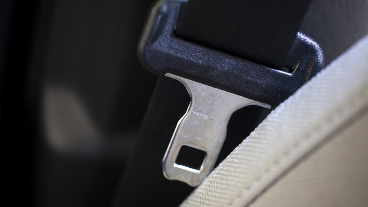 A seat belt for the right front passenger seat is shown in a vehicle.