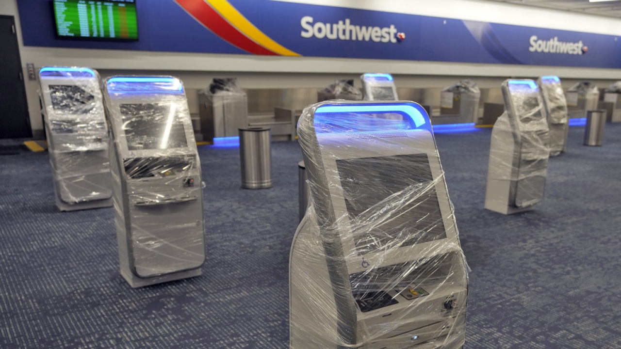 Kiosks at the Southwest Airlines ticket counter are covered in protective wrapping at the Tampa International Airport.