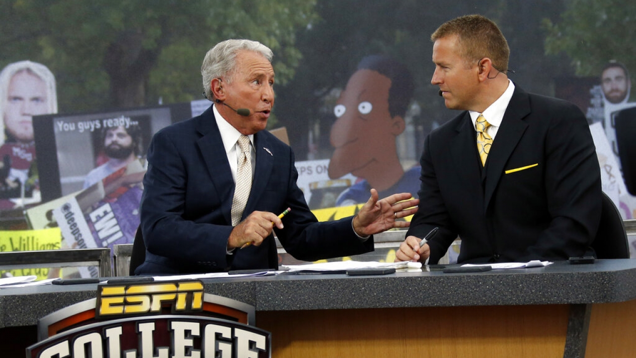 ESPN College GameDay hosts Lee Corso, left, and Kirk Herbstreit confer during a telecast.