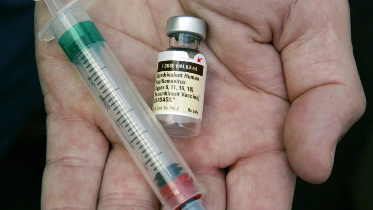 A vial of the human papillomavirus (HPV) vaccine and a syringe.