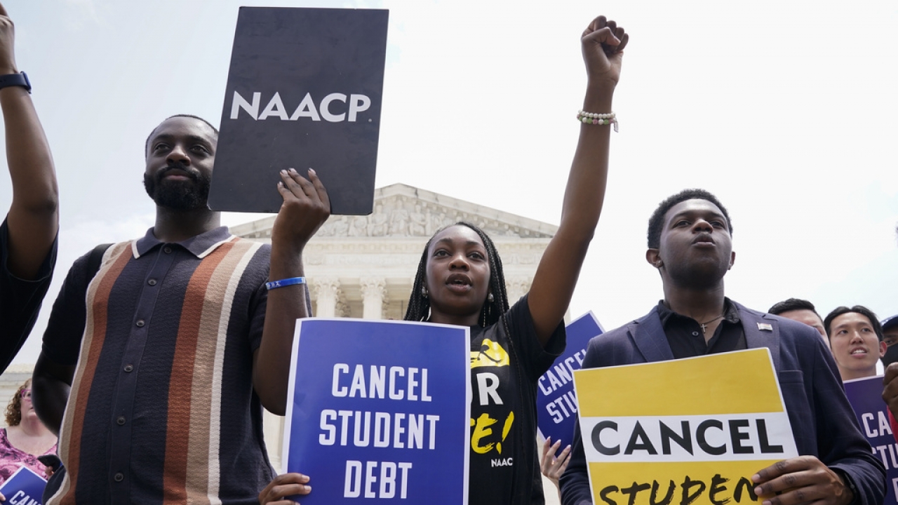 Protest outside of Supreme Court calls for canceling student loan debt.