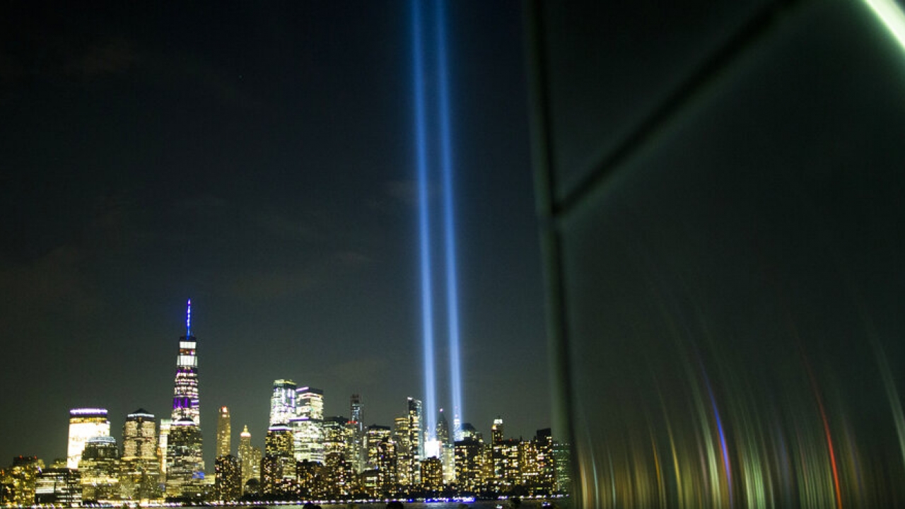 People watch the Tribute in Light as it rises above the lower Manhattan skyline.