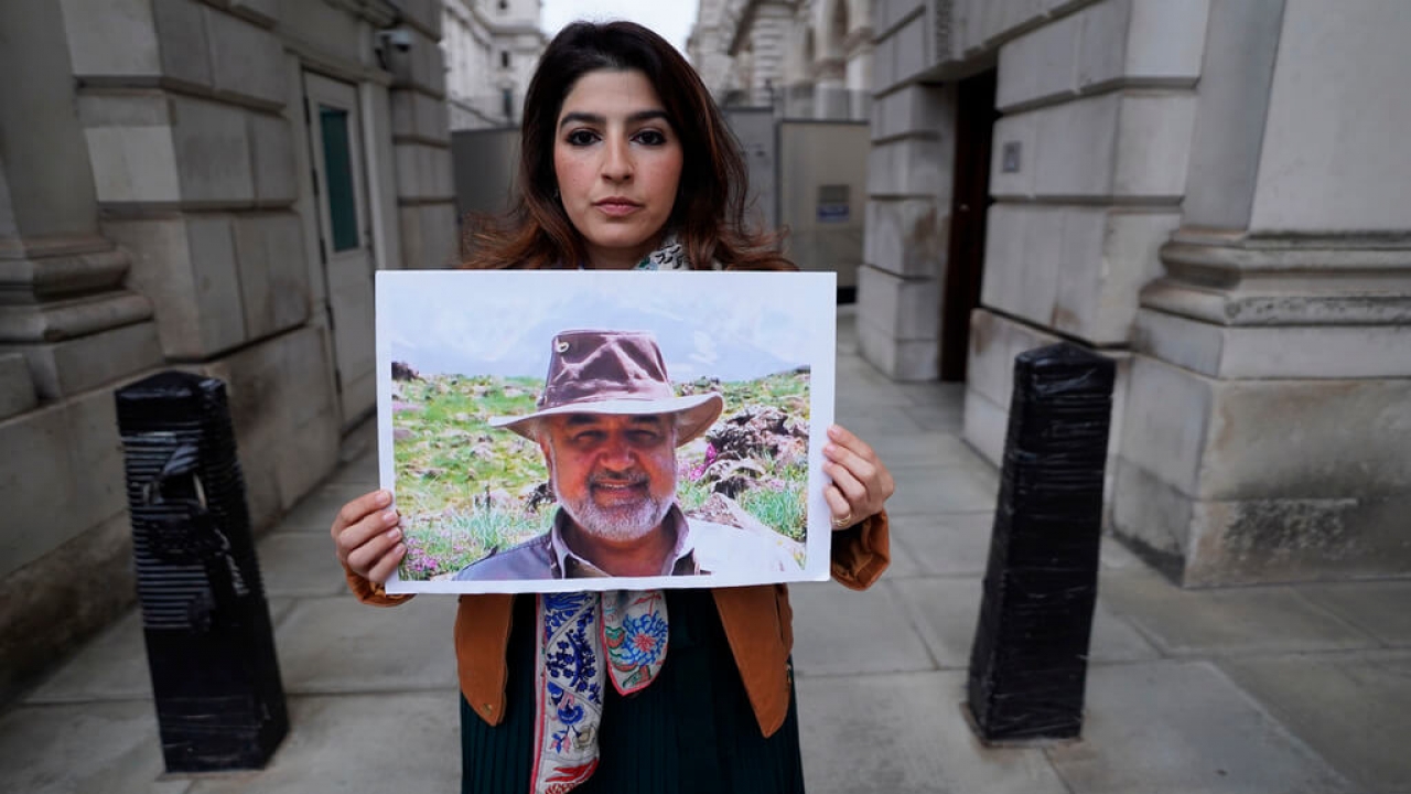 Roxanne Tahbaz holds a picture of her father Morad Tahbaz who is jailed in Iran