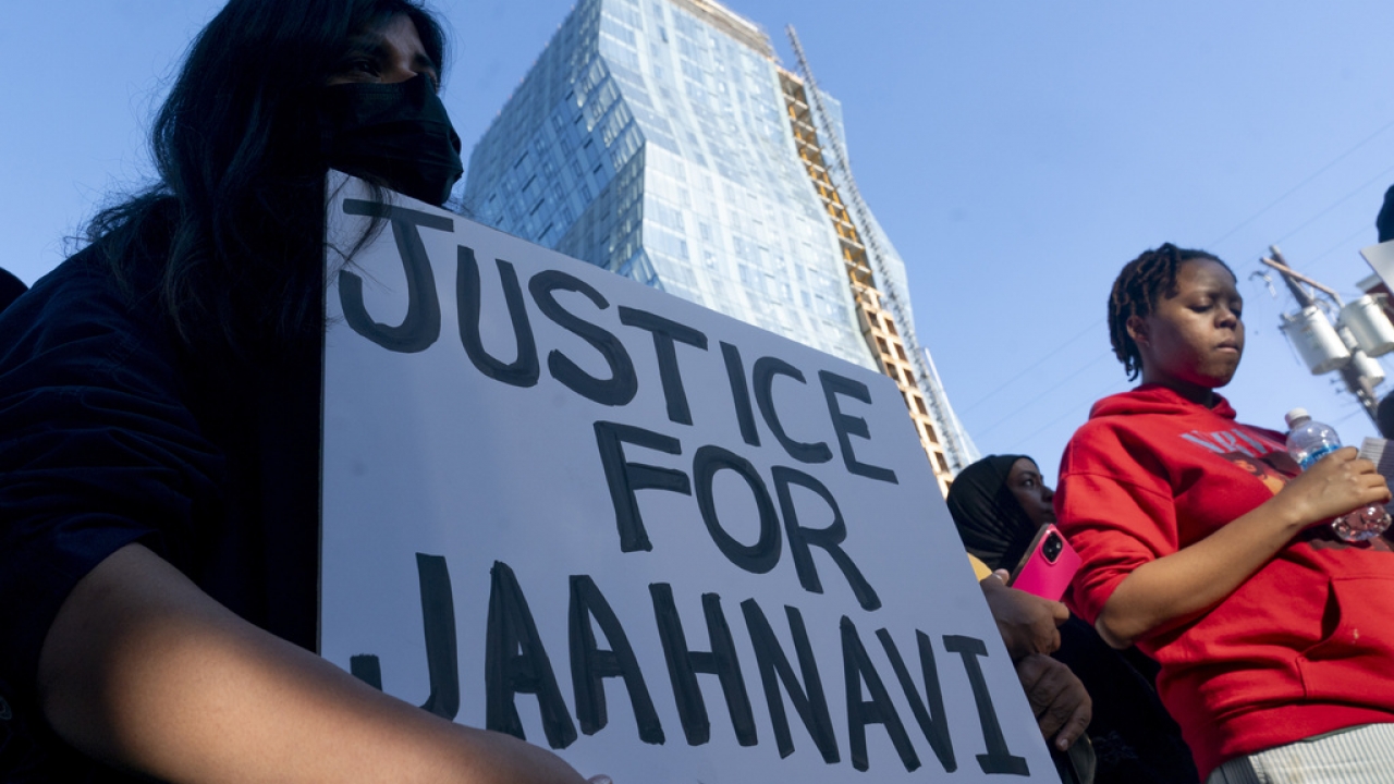 A protester holds a sign that states "Justice for Jaahnavi" in Seattle after the death of the graduate student.