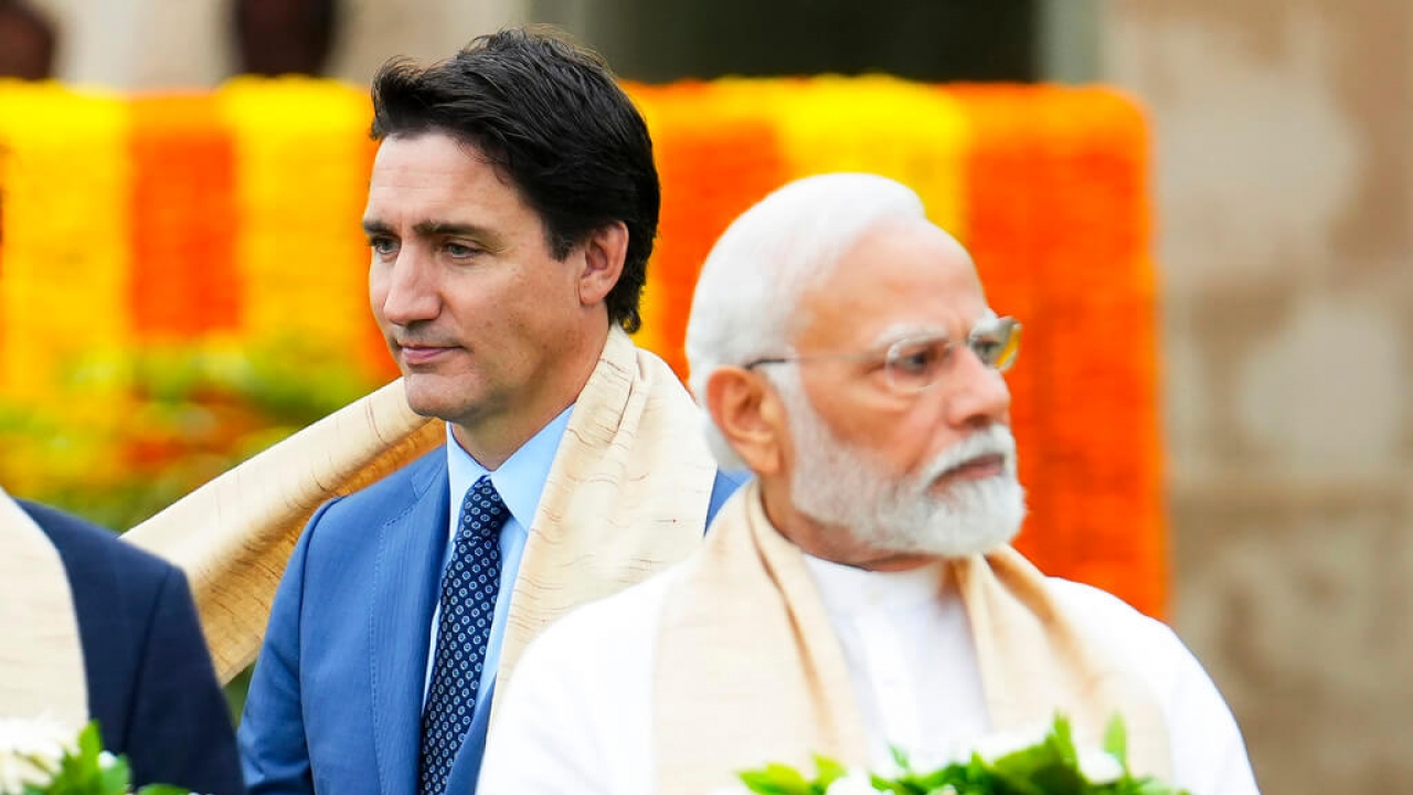 Canada's Prime Minister Justin Trudeau, left, walks past Indian Prime Minister Narendra Modi