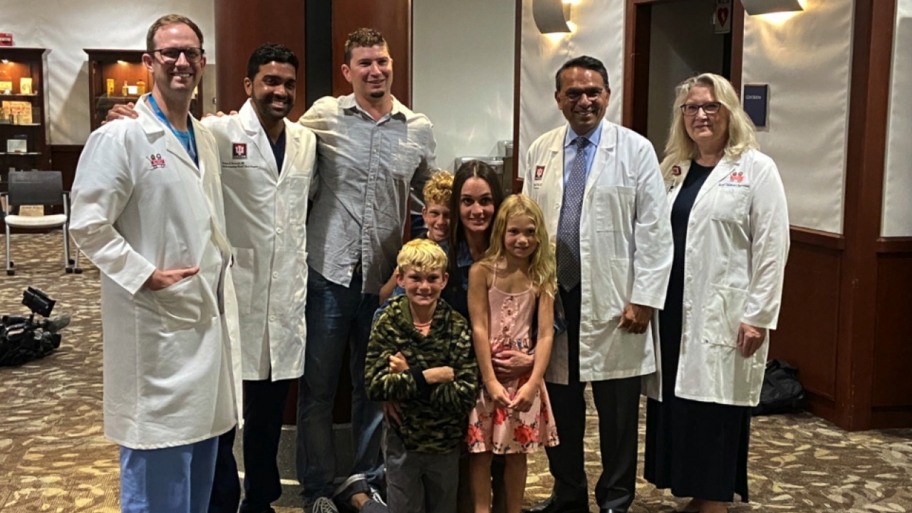 Riley and her family pose with medical staff