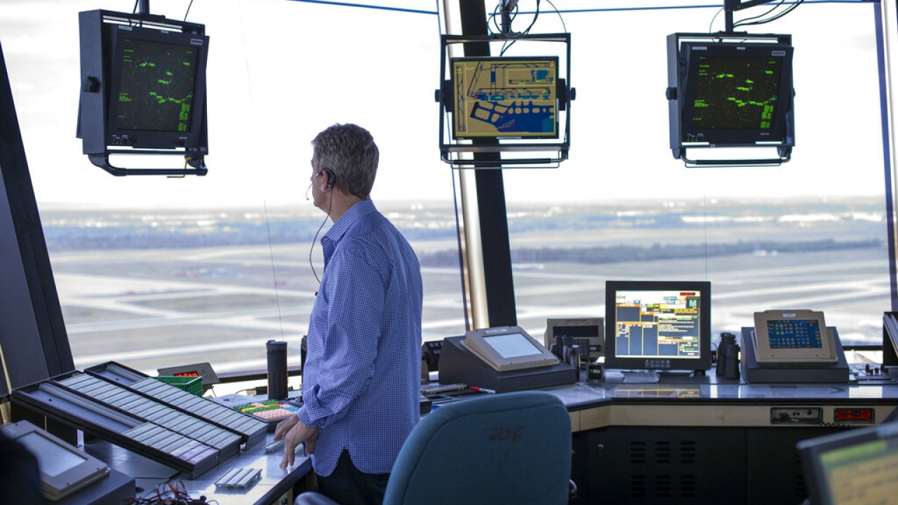 An FAA air traffic controller works in the Dulles International Airport Air Traffic Control Tower in Sterling, Va.